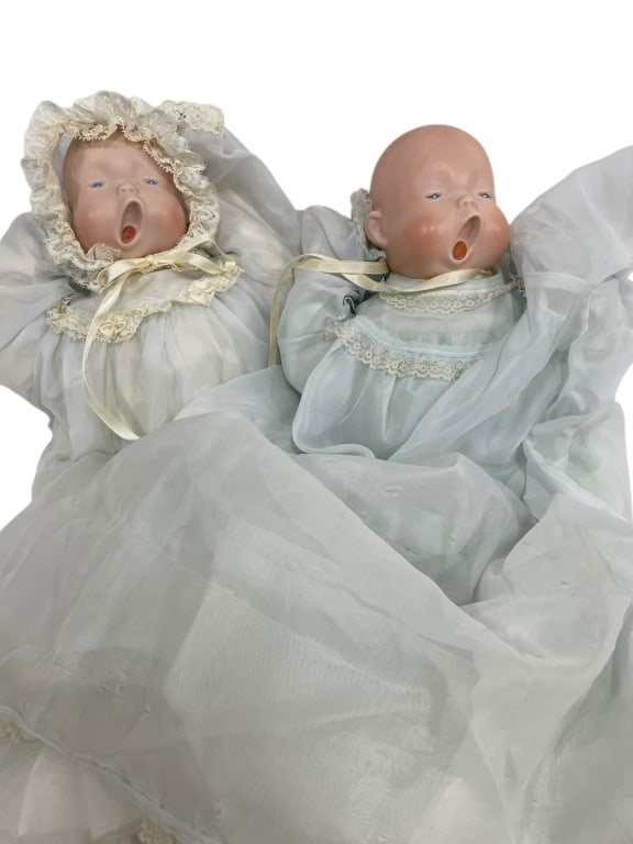 VINTAGE PAIR YAWNING SLEEPING TWIN BABY DOLLS: VINTAGE PAIR YAWNING SLEEPING TWIN BABY DOLLS IN CHRISTENING OUTFITS This captivating pair of vintage twin baby dolls features expressive faces with open, yawning mouths, suggesting a peaceful slumber