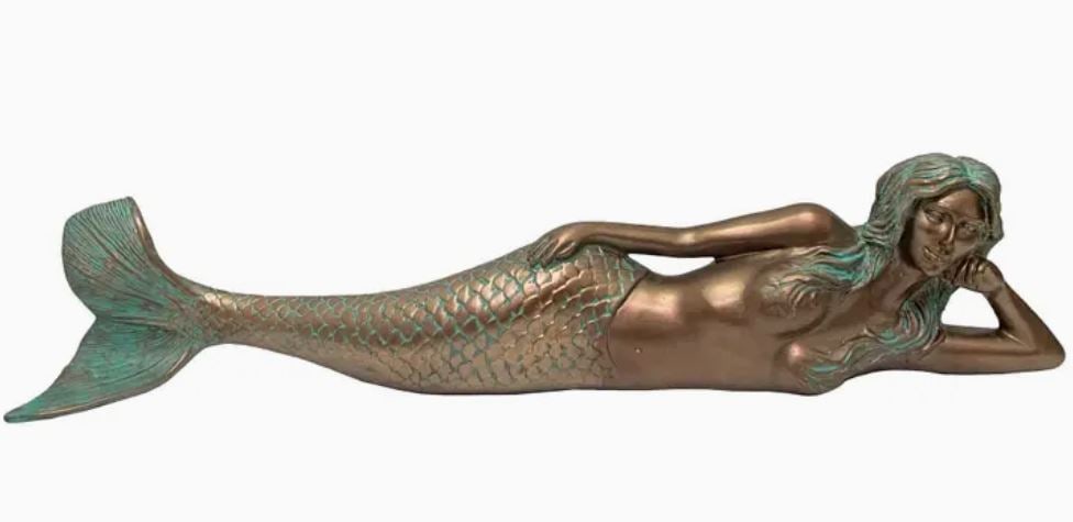 BRONZE DREAMY LYING MERMAID 25"L: DREAMY LYING MERMAID BRONZE -Add a flair of elegance and charm to your home with Dreamy the Mermaid. Constructed out of resin, this beautiful mermaid is depicted lying on her side as she ponders. Drea