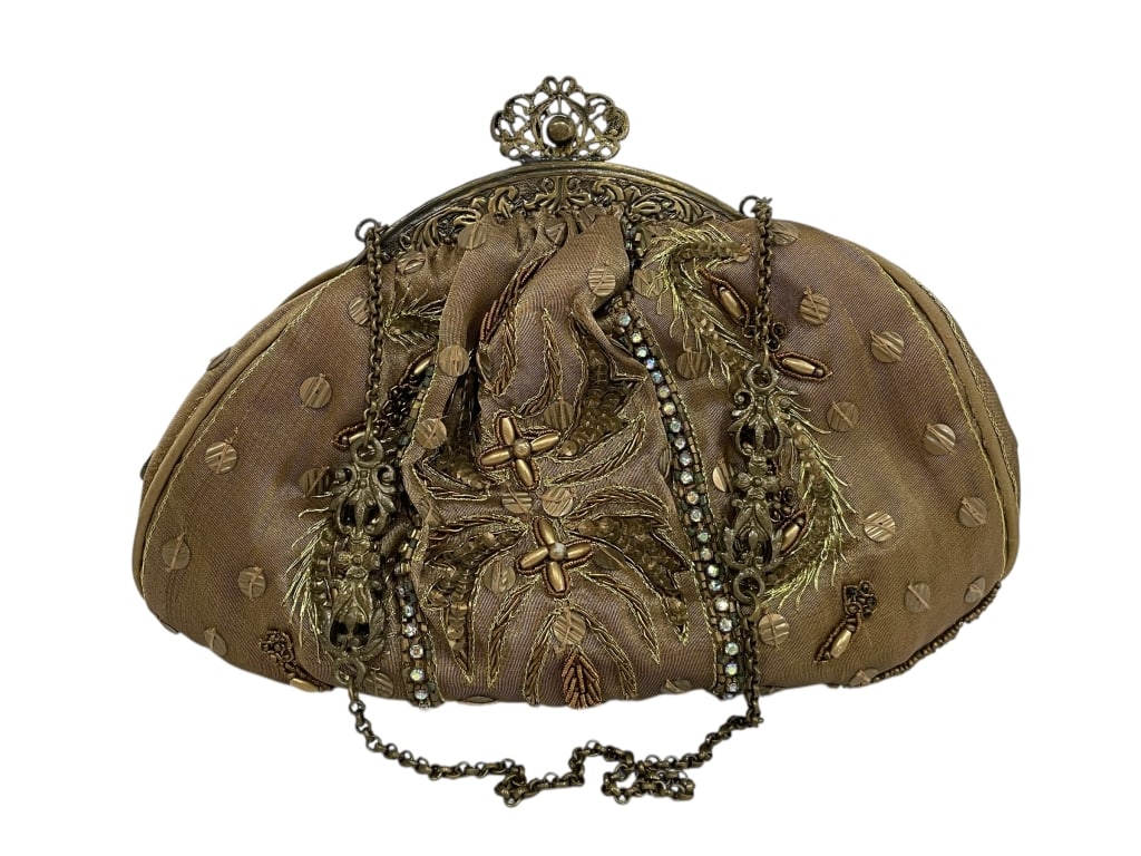 NOLY FUENTES SL EMBELLISHED EVENING CLUTCH: NOLY FUENTES SL EMBELLISHED EVENING CLUTCH WITH ORNATE FRAME & CHAIN STRAP -Good pre owned condition, see photos -Approx 7"h x 9"w -Crafted in champagne-gold toned fabric richly adorned with intricate