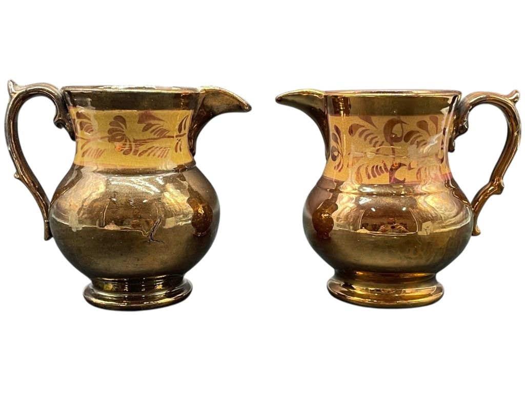 PAIR OF ANTIQUE ENGLISH COPPER LUSTREWARE CREAMERS: ANTIQUE ENGLISH COPPER LUSTREWARE CREAMERS -A handsome pair of antique English copper lustreware creamers featuring rich reflective copper glaze with a contrasting ochre band decorated with stylized f