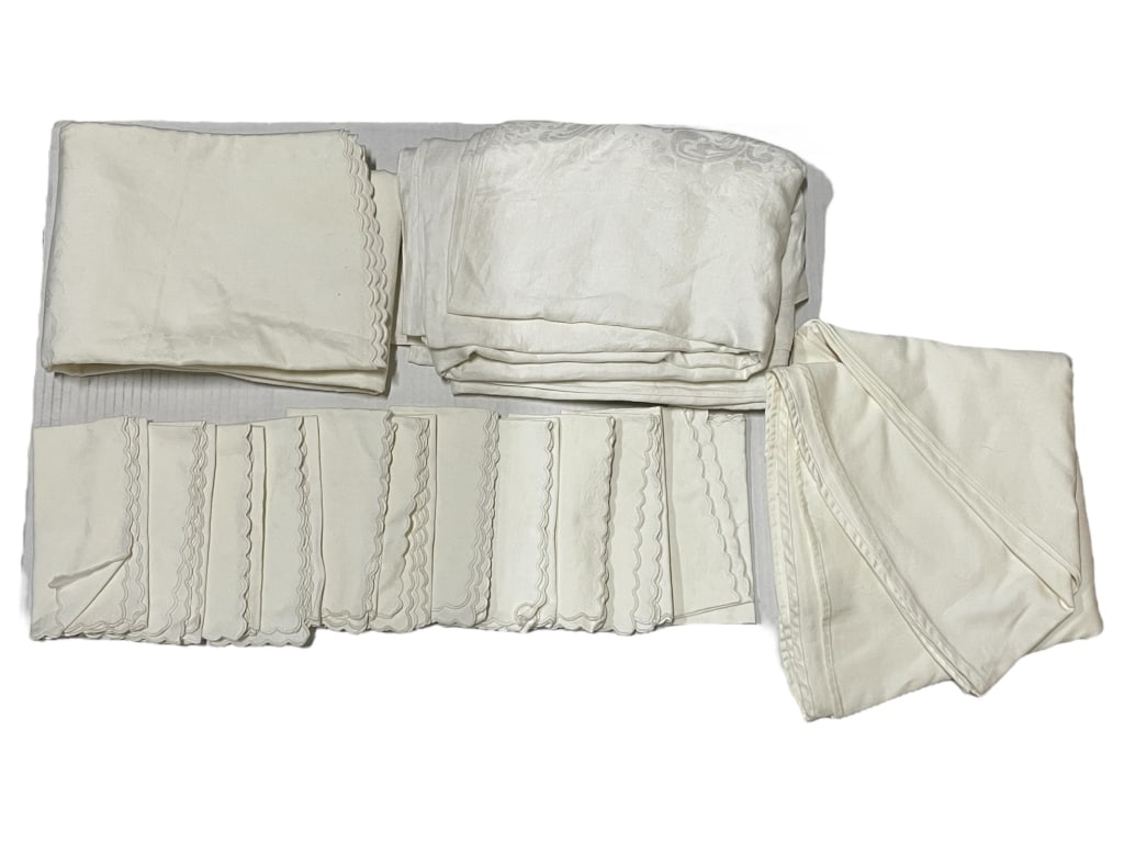ASSORTED GROUP OF IVORY TABLE LINENS: ASSORTED GROUP OF IVORY TABLE LINENS INCLDUING 3 TABLECLOTHS AND 11 NAPKINS -Pre owned condition, some stains/ discoloration -This linen group is perfect for special occasions or everyday dining with