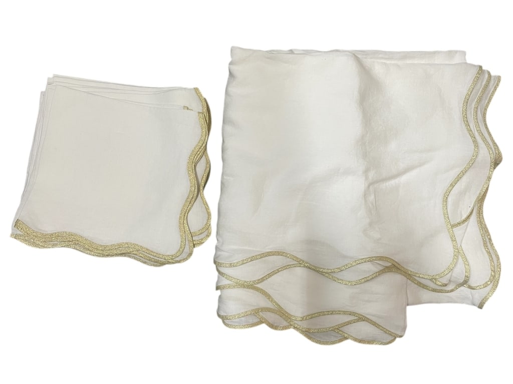 ELEGANT IVORY TABLE LINENS WITH GOLD TRIM: ELEGANT IVORY TABLE LINENS WITH GOLD TRIM TABLECLOTH AND 12 NAPKINS -Good pre owned condition -Attractive group of linen table linens in a soft ivory tone, finished with decorative gold trim along the