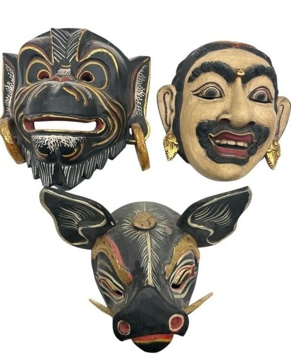 SET OF THREE BALINESE HAND-CARVED WOODEN MASKS 10": - A STRIKING COLLECTION OF TRADITIONAL BALINESE CEREMONIAL MASKS, EACH INTRICATELY CARVED AND PAINTED BY HAND. FEATURES INCLUDE A FIERCE BOAR MASK WITH GOLD ACCENTS, A SMILING BEARDED MALE FIGURE WITH