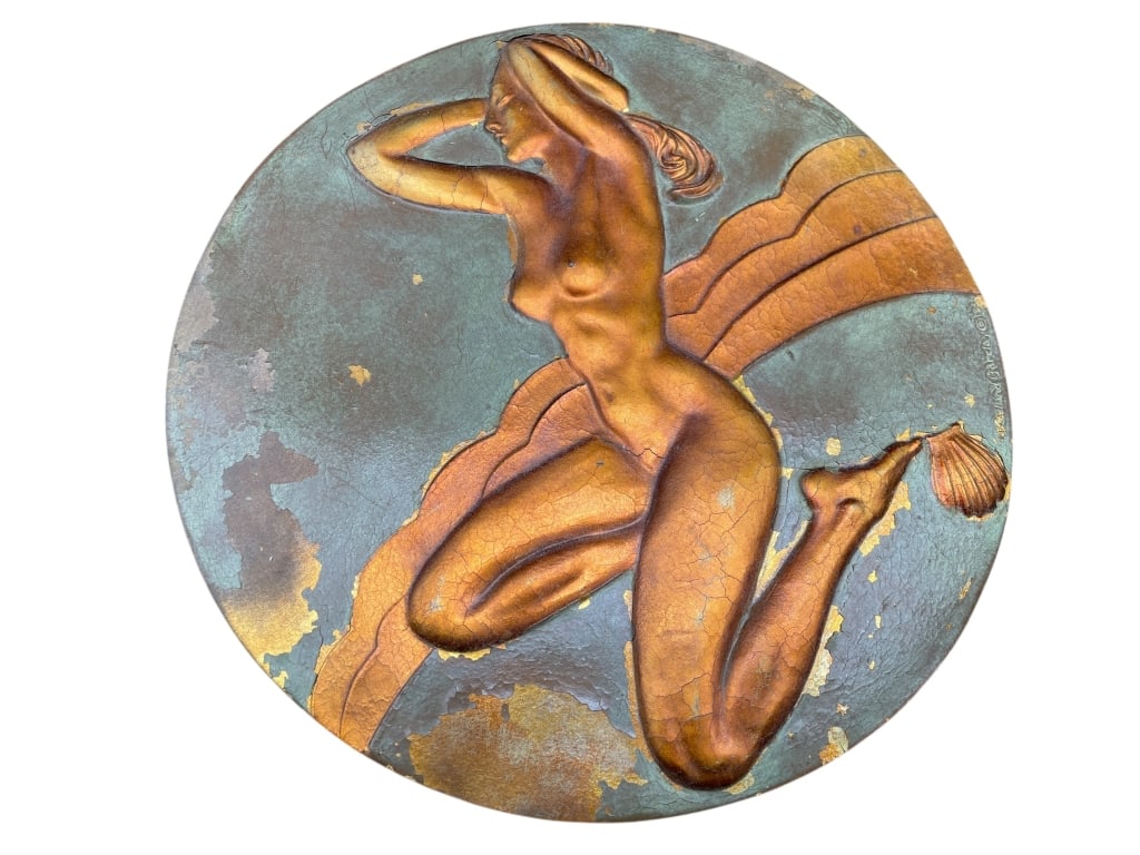 ART DECO STYLE RELIEF PLAQUE OF NUDE FEMALE FIGURE: This round decorative relief plaque depicts a classical nude female figure in a dynamic, flowing pose, rendered in raised relief against a contrasting background. The composition reflects Art Nouveau�