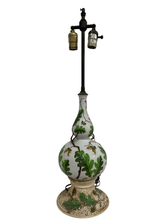 CERAMIC TABLE LAMP W OAK LEAF MOTIF 26": CERAMIC TABLE LAMP W OAK LEAF MOTIF 26" -Very good pre owned condition, not tested -Approx 26" tall -This decorative table lamp features a hand-painted ceramic body adorned with a raised oak leaf and