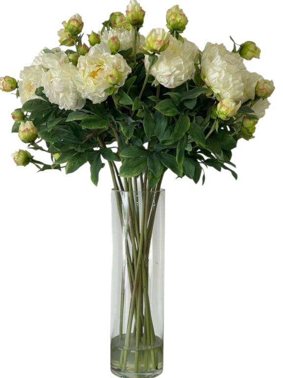 FAUX FLORAL ARRANGEMENT WHITE BLOOMS W VASE 38": FAUX FLORAL ARRANGEMENT OF WHITE BLOOMS IN CLEAR GLASS VASE 38" X 24" APPROX -Decorative faux floral arrangement featuring white peony-style blooms with green foliage arranged in a clear cylindrical g