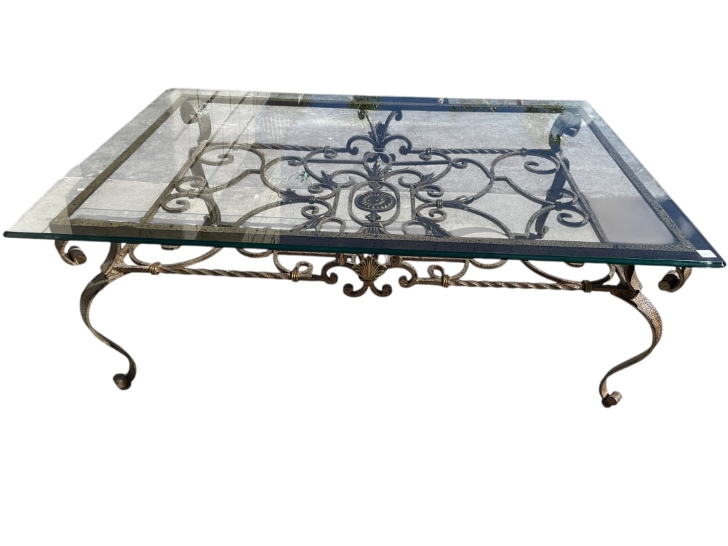 WROUGHT IRON AND GLASS COFFEE TABLE 56": WROUGHT IRON AND GLASS COFFEE TABLE WITH ORNATE SCROLLWORK BASE 20" X 56" X 38" APPROX -Rectangular glass-top coffee table featuring a clear beveled glass surface resting on an ornate wrought iron bas