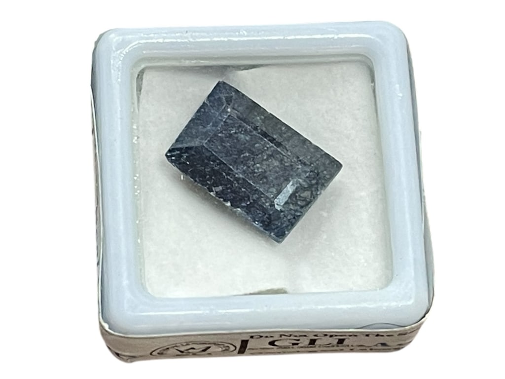 NATURAL BLUE SAPPHIRE ROUGH SPECIMEN 12.25 CARATS: NATURAL BLUE SAPPHIRE ROUGH SPECIMEN, 12.25 CARATS, GLI SEALED & CERTIFIED-This natural blue sapphire is presented in its original rough, uncut form and weighs approximately 12.25 carats. The stone