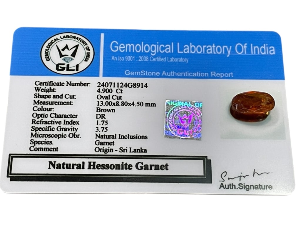 NATURAL HESSONITE GARNET 4.90 CT OVAL CUT: NATURAL HESSONITE GARNET – 4.90 CT OVAL CUT, SRI LANKA-Certified by the Gemological Laboratory of India (GLI), this natural hessonite garnet weighs approximately 4.90 carats and is fashioned in an
