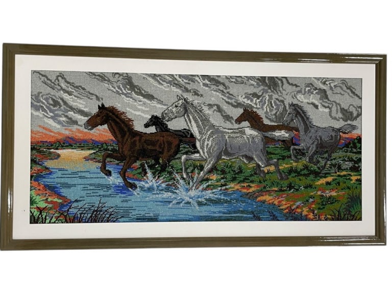FRAMED BEADED NEEDLEPOINT OF HORSES WALL ART 48": FRAMED BEADED NEEDLEPOINT ART DEPICTING HORSES IN LANDSCAPE 48" X 25" -Detailed beaded needlepoint textile artwork depicting horses in motion against a scenic landscape with dramatic sky and water ele