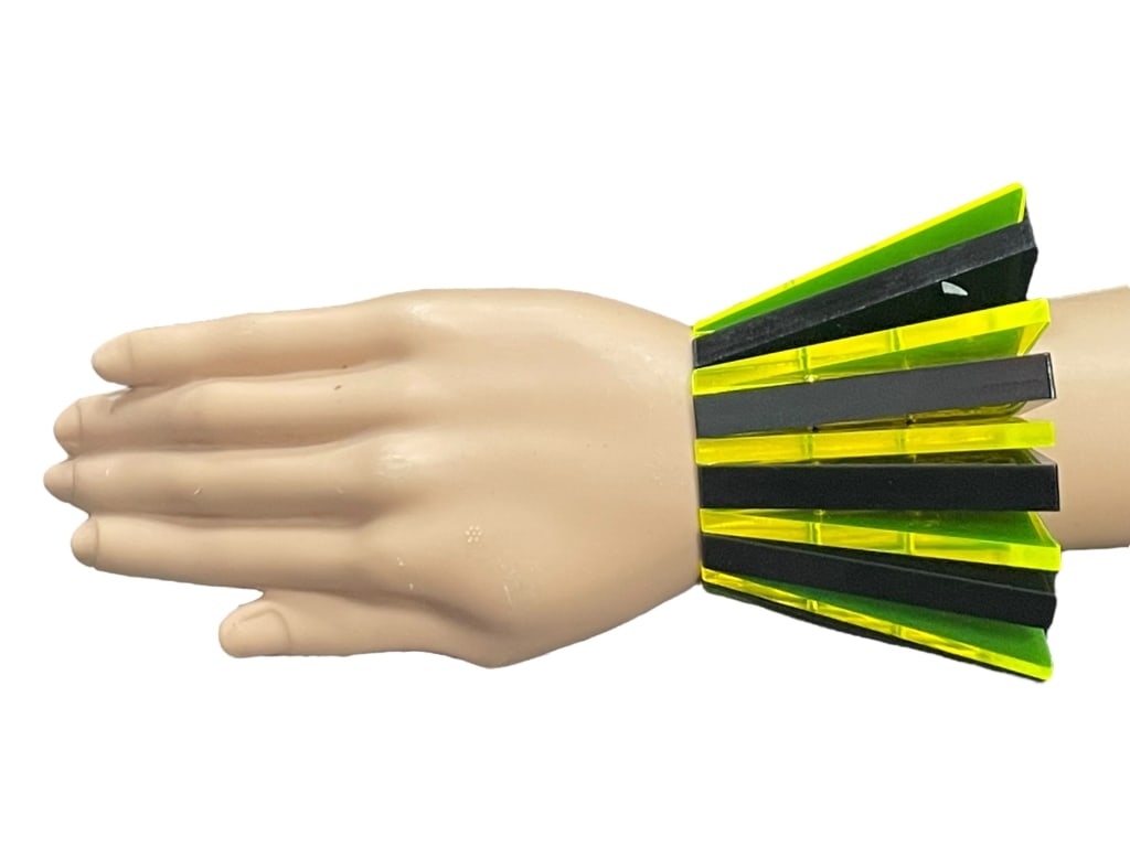 HOUSE OF FLORA BOLD WEDGE YLW BLK LUCITE BRACELET: - House of Flora flourescent yellow and black - Mod bracelet with bold pieces of LUCITE pieced together for a futuristic look - Stretches to wear - New condition - Signed House of Flora - New conditio