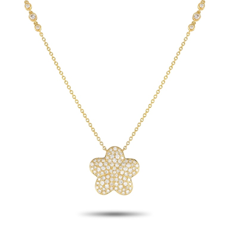 18K YELLOW GOLD 1.25CT DIAMOND NECKLACE: This exquisitely crafted necklace will continually captivate. Diamonds with a total weight of 1.25 carats accent the 18 chain as well as the flower-shaped pendant at the center of the design. Crafted