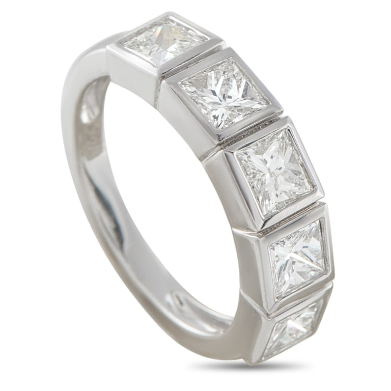 18K WHITE GOLD 1.80CT DIAMOND PRINCESS RING 5.75: An 18K white gold ring set with five princess-cut diamonds, each framed in a smooth bezel that emphasizes their sharp geometry. Arranged in a neat line across the band, the 1.80 carats diamonds return