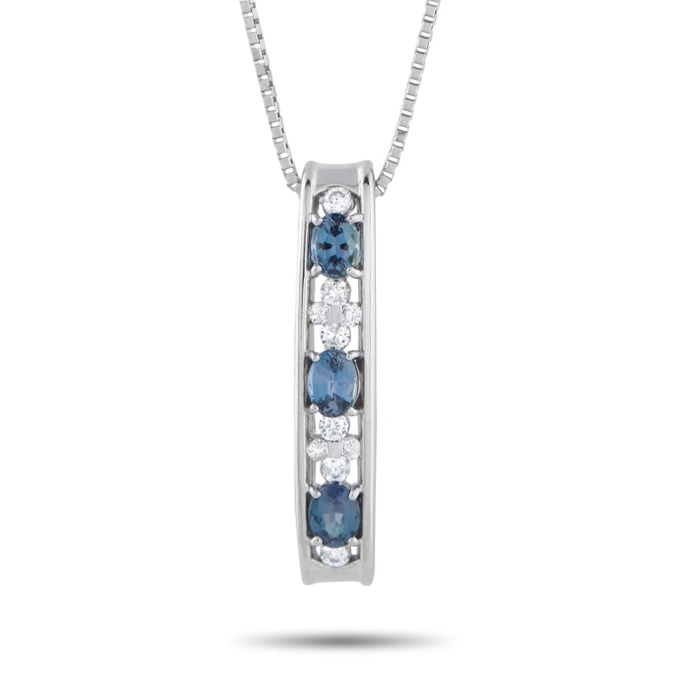 PLATINUM 0.10CT DIAMOND AND ALEXANDRITE NECKLACE: A slender vertical bar serves as the pendant of this LB 850 platinum necklace. It glimmers with quiet intrigue, showcasing an alternating pattern of oval elxandrites and round diamonds. A fine box cha