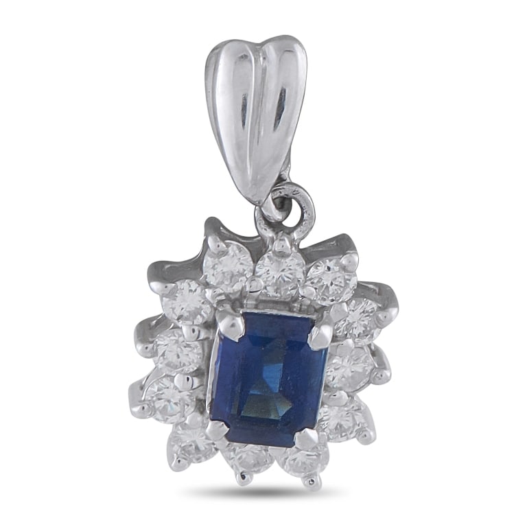 PLATINUM 0.38CT DIAMOND AND SAPPHIRE PENDANT: Petite in scale, the design of this pendant relies on the sapphire's depth of color rather than size. It is presented with an emerald-cut sapphire, a choice that favors clarity and even saturation ove
