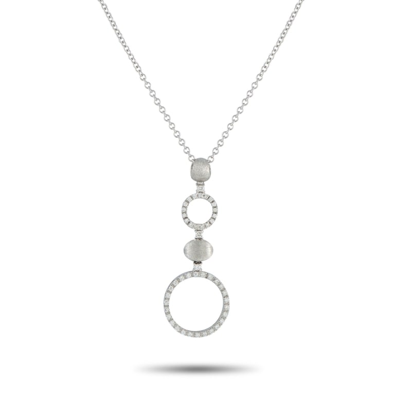NANIS 18K WHITE GOLD 0.65CT DIAMOND NECKLACE: A sleek, contemporary design makes this Nanis necklace an elegant addition to any jewelry collection. Set in 18K White Gold, the circular forms are elevated by sparkling Diamonds with a total weight o
