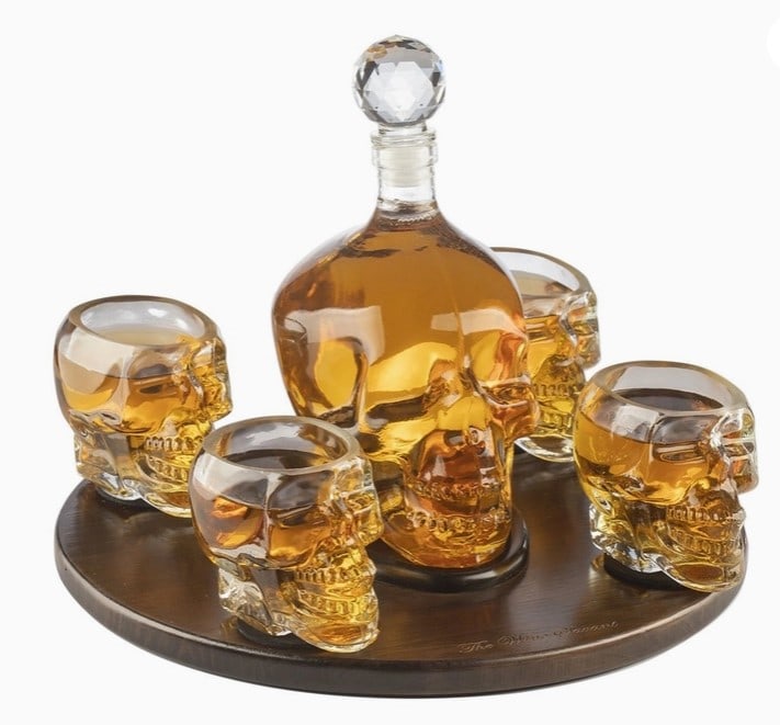 NEW! SKULL DECANTER SET: Skull Decanter Set & 4 Skeleton Shot Glasses THE SAVANT SKULL DECANTER AND GLASSES EXPERIENCE Entertain with the daring and dramatic. Our outstanding glass decanter adds a unique accent to a home bar.