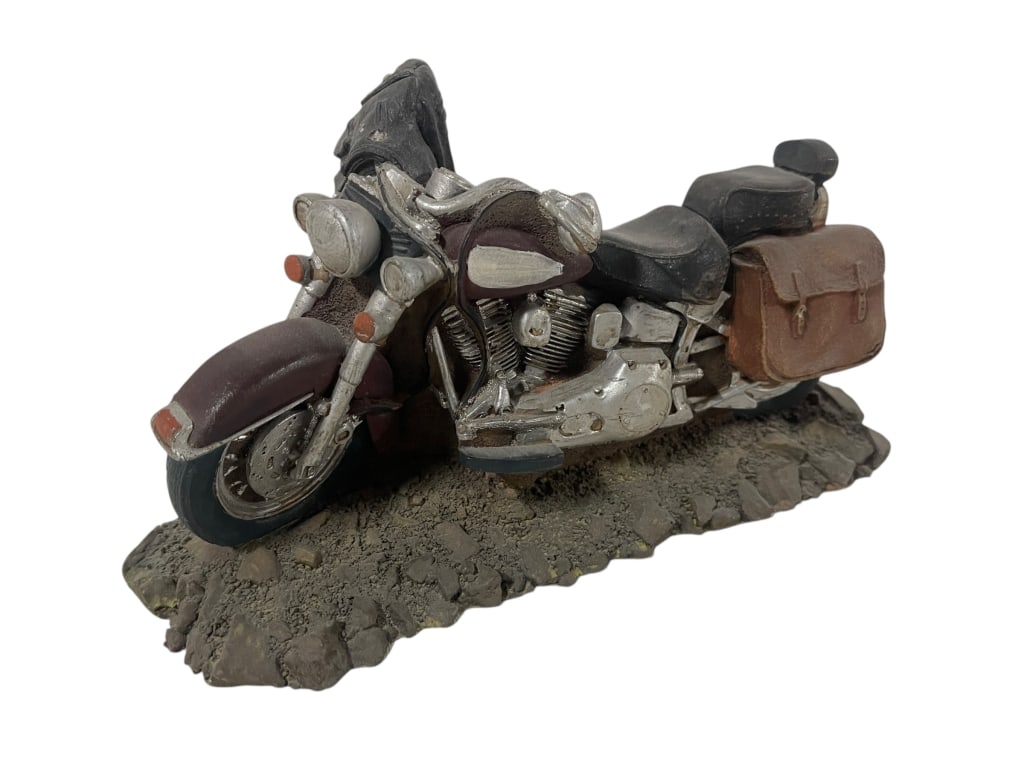 COLLECTIBLE MOTORCYCLE RESIN SCULPTURE: COLLECTIBLE MOTORCYCLE RESIN SCULPTURE This detailed resin sculpture depicts a classic cruiser-style motorcycle resting on a rocky terrain base. The bike features a deep maroon and silver paint scheme
