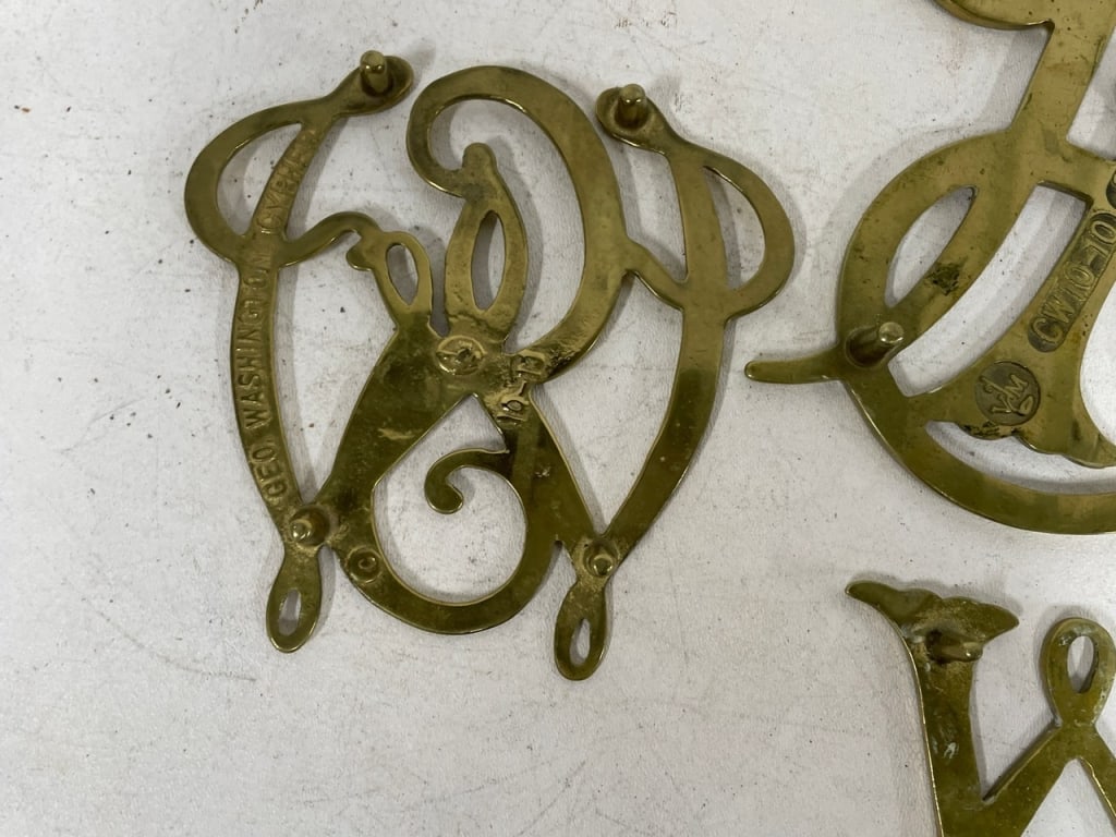 DECORATIVE BRASS MONOGRAM & SCROLLWORK TRIVETS - 11