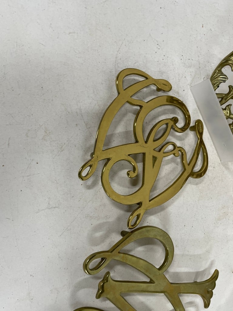 DECORATIVE BRASS MONOGRAM & SCROLLWORK TRIVETS - 8