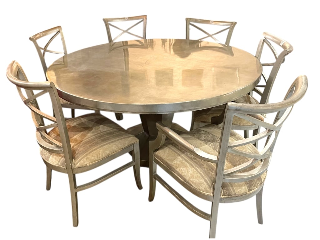 SILVER TRADITIONAL DINING TABLE WITH 6 CHAIRS: SILVER TRADITIONAL DINING TABLE WITH 6 CHAIRS UPHOLSTERED CHAIRSRound traditional dining table featuring a substantial circular top with a smooth, softly reflective finish in warm neutral tones. The t