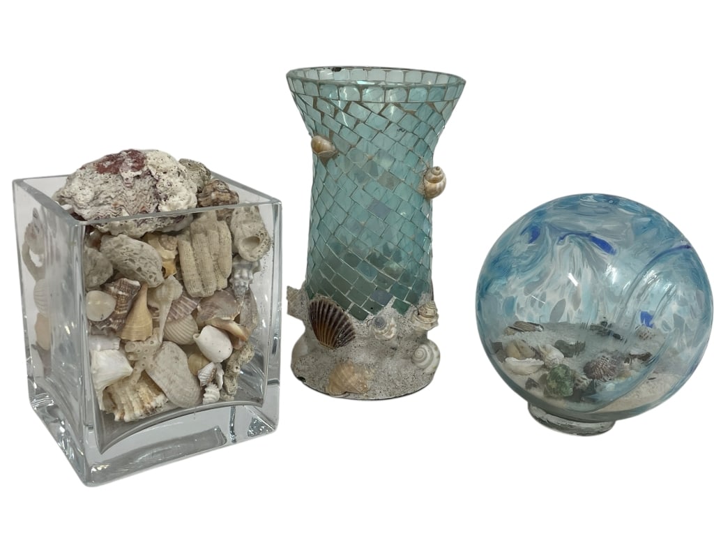 COASTAL DECOR LOT: COASTAL DECOR LOT – SHELL-FILLED GLASS VESSEL, MOSAIC VASE & GLASS ORB -Decorative coastal-themed grouping including a clear square glass vessel filled with assorted seashells, a mosaic-style blue g
