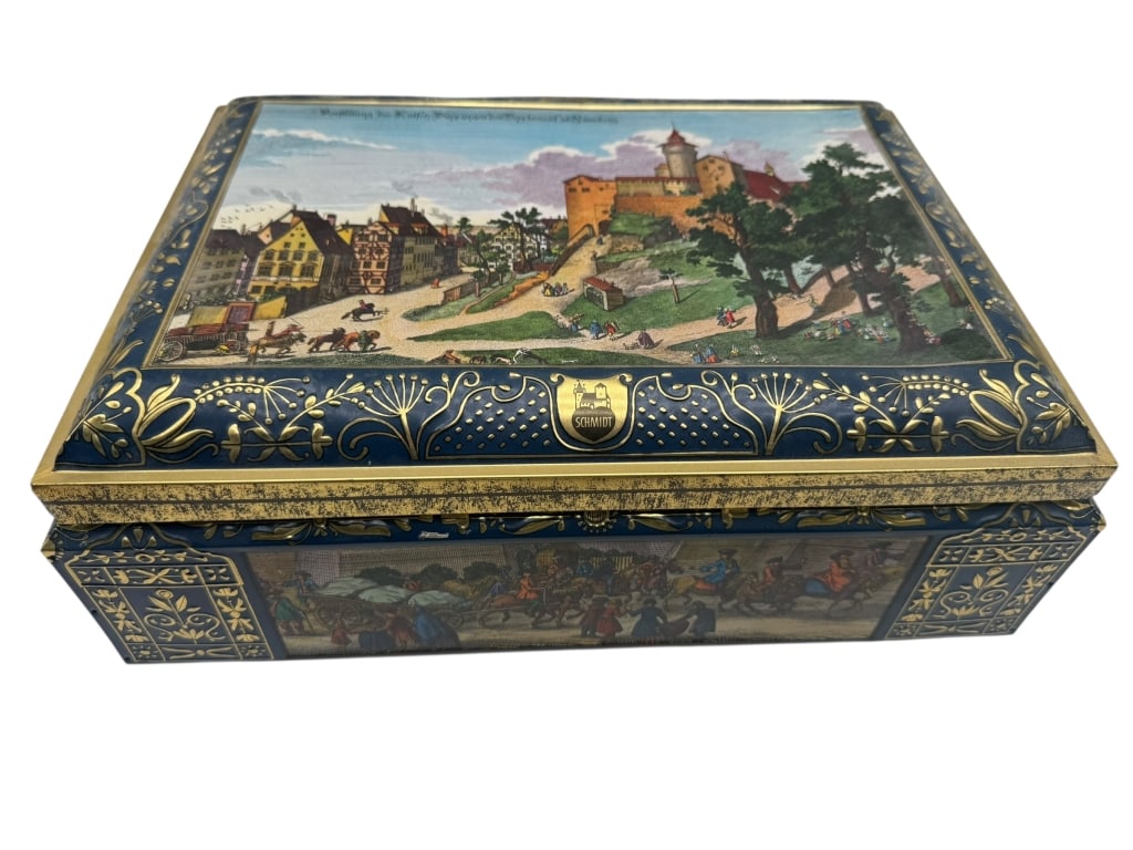 SCHMIDT DECORATIVE EUROPEAN SCENIC TIN BOX: SCHMIDT DECORATIVE EUROPEAN SCENIC TIN BOX -Decorative metal tin box by Schmidt featuring detailed European town and castle scenes rendered in rich colors with ornate gilt-accented borders. The hinged