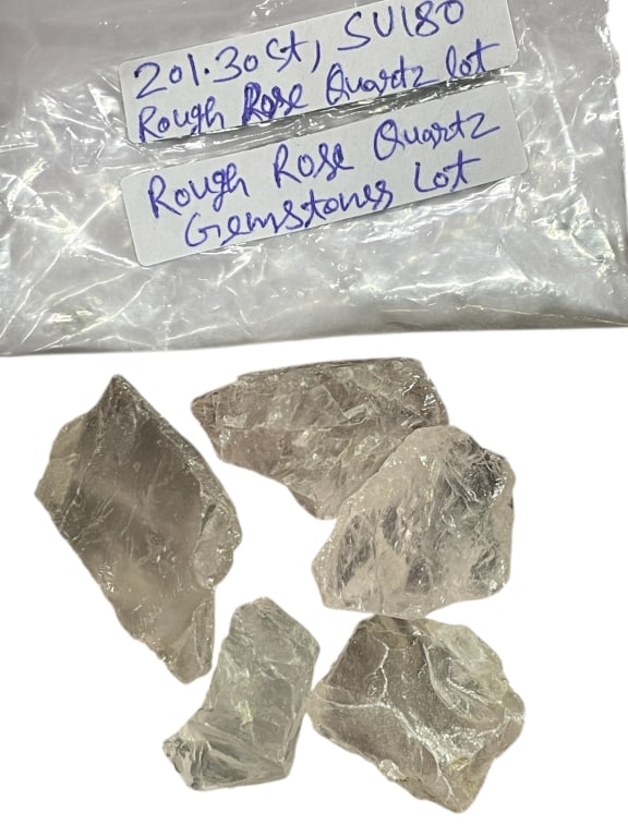 ROUGH ROSE QUARTZ GEMSTONE LOT 201.30 CARATS: ROUGH ROSE QUARTZ GEMSTONE LOT – APPROX. 201.30 TOTAL CARATS -A substantial lot of natural rough rose quartz gemstones totaling approximately 201.30 carats, featuring multiple chunky, translucent to