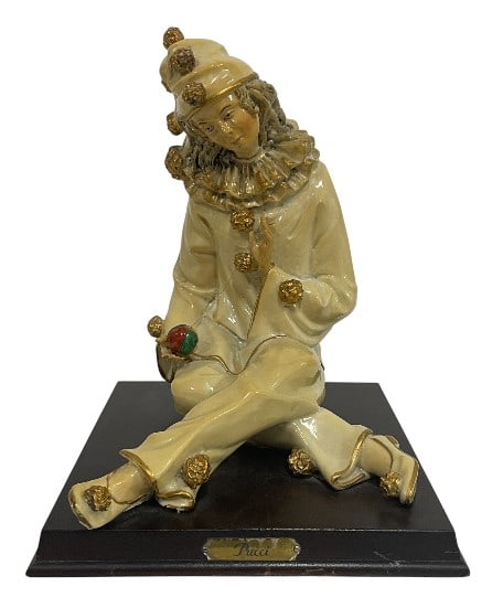 PORCELAIN CLOWN FIGURINE SIGNED "PUCCI": ****for competitive shipping options please go to www.dejavuauctionshipping.com PORCELAIN CLOWN FIGURINE SIGNED "PUCCI" ON WOOD BASE -Very good pre owned condition -Approx 10"h x 7"w x 8"d -Rendered i