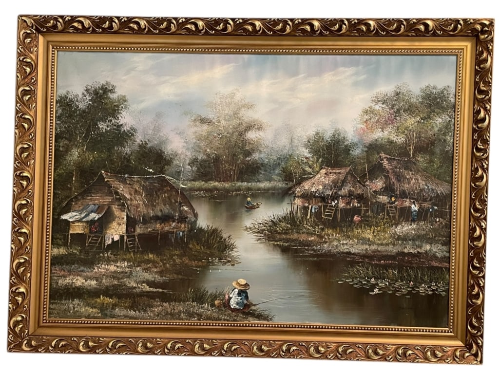 LARGE RIVER VILLAGE LANDSCAPE PAINTING 50.5": FRAMED RIVER VILLAGE LANDSCAPE PAINTING WITH THATCHED HUTS AND FIGURES -Large framed landscape painting depicting a tranquil riverside village scene with traditional thatched huts on stilts, lush foli