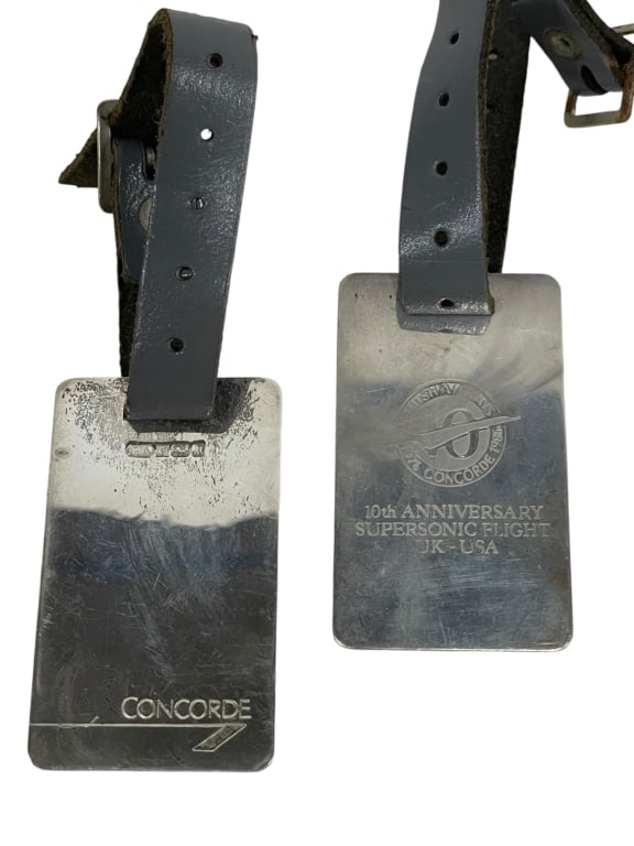 CONCORDE SUPSERSONIC FLIGHT METAL LUGGAGE TAGS '86: PAIR OF CONCORDE 10TH ANNIVERSARY SUPSERSONIC FLIGHT METAL LUGGAGE TAGSPair of vintage Concorde luggage tags including one commemorating the “10th Anniversary Supersonic Flight UK – USA” fea