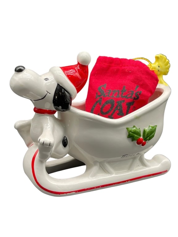 PEANUTS SNOOPY & WOODSTOCK CERAMIC FIGURINE: For ALTERNATE shipping quote or LOCAL PICK-UP DETAILS, please visit dejavuauctionshipping.com PEANUTS SNOOPY & WOODSTOCK SANTA’S COAT CERAMIC CHRISTMAS SLEIGH FIGURINE Charming licensed Peanuts holi