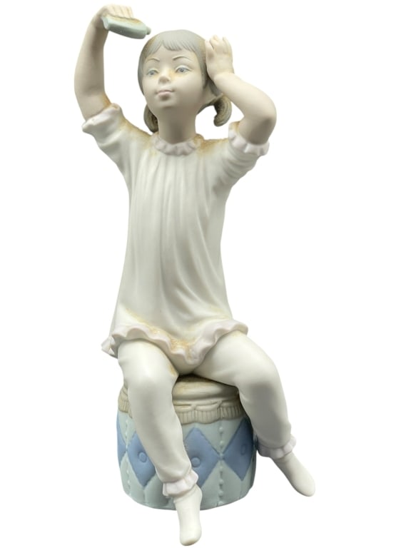 LLADRO GIRL SHAMPOOING HAIR PORCELAIN FIGURINE 8": LLADRO GIRL SHAMPOOING HAIR #1148 PORCELAIN FIGURINE -Charming Lladró porcelain figurine titled Girl Shampooing Hair (#1148), depicting a young girl seated on a quilted blue drum stool, lifting a bar