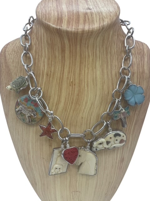 SUE MILAGRO MASSIVE CHARMS CHAIN NECKLACE 138G: *For ALTERNATIVE SHIPPING QUOTES or local PICKUP details, please visit www.dejavuauctionshipping.com* Designer Sue Milagro sterling silver charm necklace featuring a substantial oval-link chain suspen