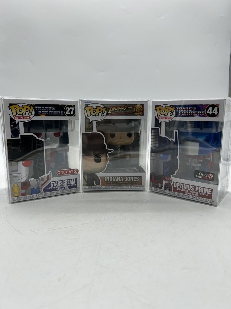 1 FUNKO POP INDIANA JONES & 2 TRANSFORMERS LOT: For ALTERNATE shipping quote or LOCAL PICK-UP DETAILS, please visit dejavuauctionshipping.comFUNKO POP RETRO TOYS STARSCREAM #27 TARGET EXCLUSIVE, INDIANA JONES #1355, OPTIMUS PRIME #44 GAMESTOP