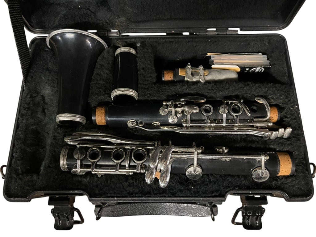 VINTAGE CLARINET WITH HARD CASE & ACCESSORIES: For ALTERNATE shipping quote or LOCAL PICK-UP DETAILS, please visit dejavuauctionshipping.comVintage clarinet presented in its fitted hard case, including multiple sections, mouthpiece, ligature, and
