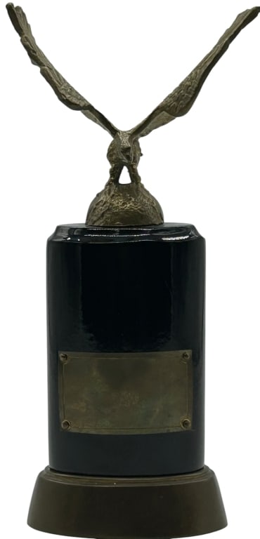 EAGLE FIGURAL TROPHY AWARD METAL SCULPTURE ON BASE: EAGLE FIGURAL TROPHY AWARD METAL SCULPTURE ON BASE Striking eagle figural trophy featuring a detailed metal sculpture of a bird of prey with wings fully outstretched, mounted atop a rounded black base