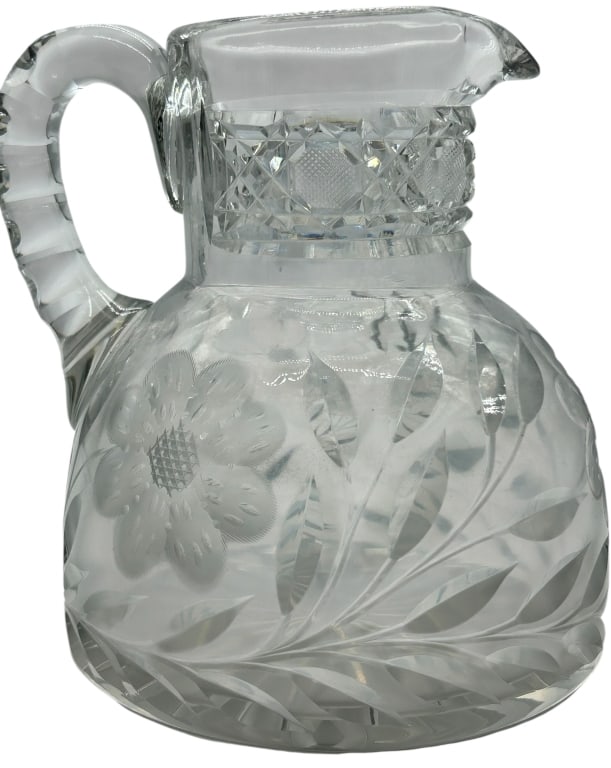 VINTAGE CUT GLASS FLORAL ETCHED SERVING PITCHER: CUT GLASS FLORAL ETCHED PITCHER VINTAGE SERVING PIECE Elegant cut and etched glass pitcher featuring a rounded body with beautifully detailed floral and leaf motif etching, complemented by a faceted b