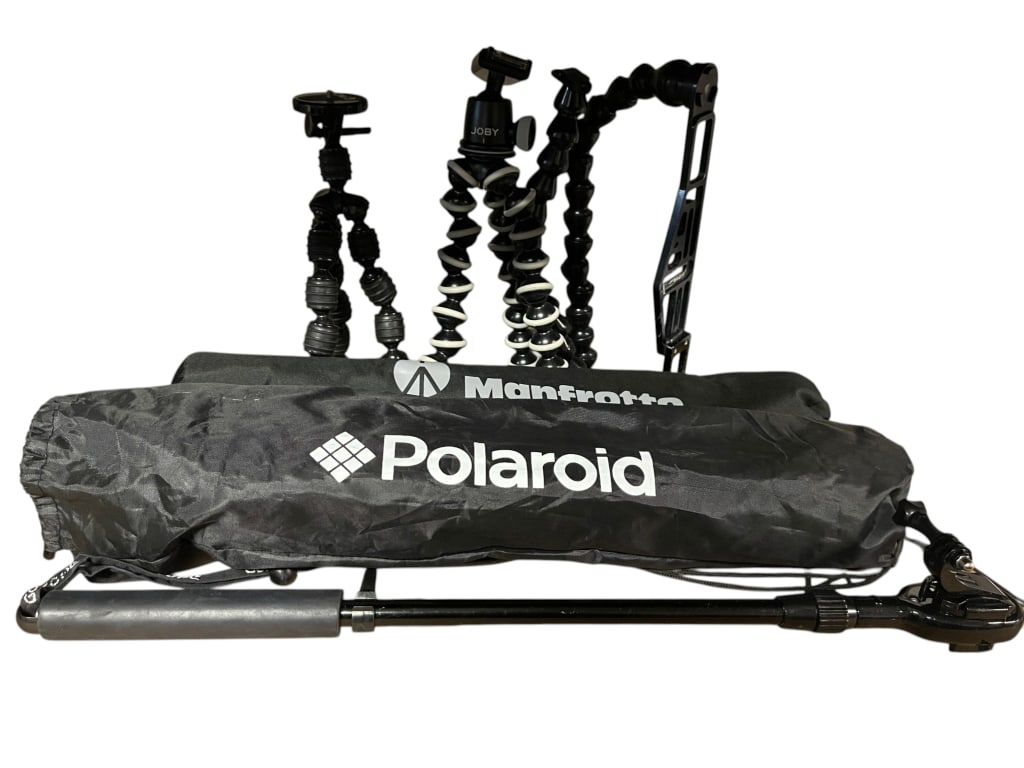 CAMERA ACCESSORY LOT GOPRO TRIPODS: For ALTERNATE shipping quote or LOCAL PICK-UP DETAILS, please visit dejavuauctionshipping.comCAMERA ACCESSORY LOT INCLUDING GoPro CASES & HOUSINGS, Manfrotto COMPACT TRIPOD, Polaroid TRIPOD, FLEXIBLE