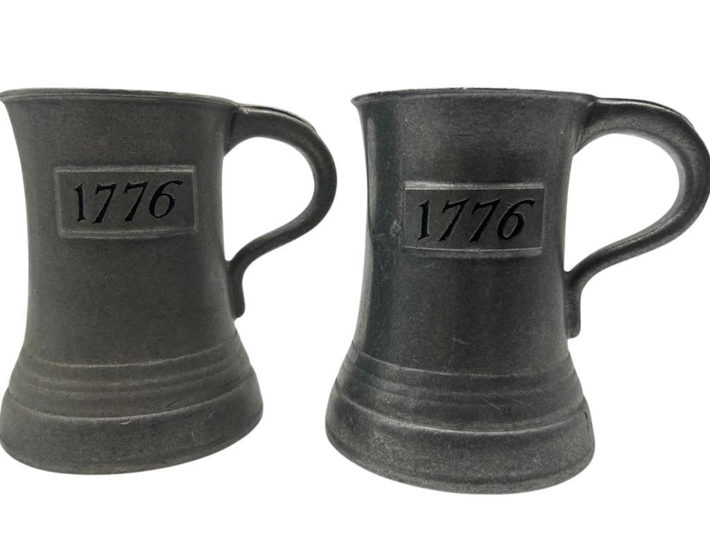 PAIR OF COMMEMORATIVE 1776 PEWTER TANKARDS 5": PAIR OF COMMEMORATIVE 1776 PEWTER TANKARDS 5" - A PATRIOTIC PAIR OF VINTAGE PEWTER TANKARDS, EACH EMBOSSED WITH "1776" IN A RAISED RECTANGULAR CARTOUCHE. FEATURING CLASSIC FLARED BASES AND ARCHED HAND