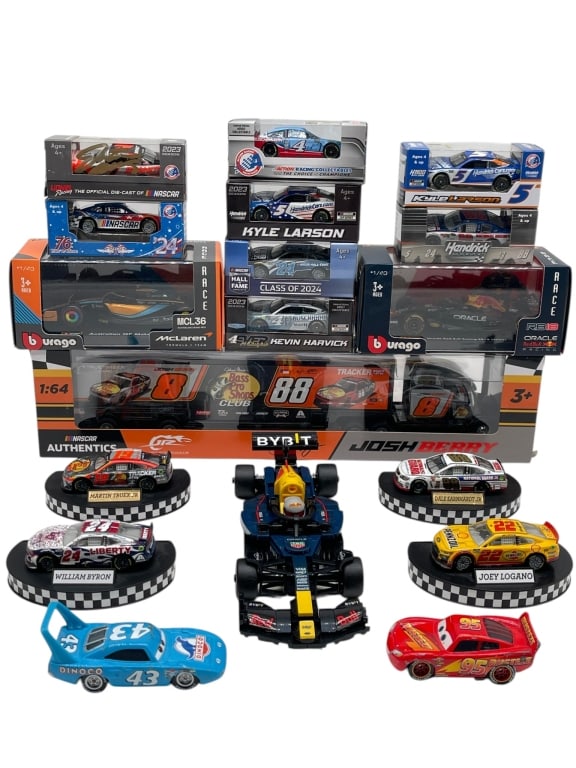 LOT OF NASCAR DIE CAST CARS FORMULA MODELS: MIXED LOT OF NASCAR DIE CAST VEHICLES BOXED MODELS AND RACING CARS Mixed lot of racing die-cast collectibles including boxed NASCAR stock cars, transport truck models, display-base race cars, a Formul