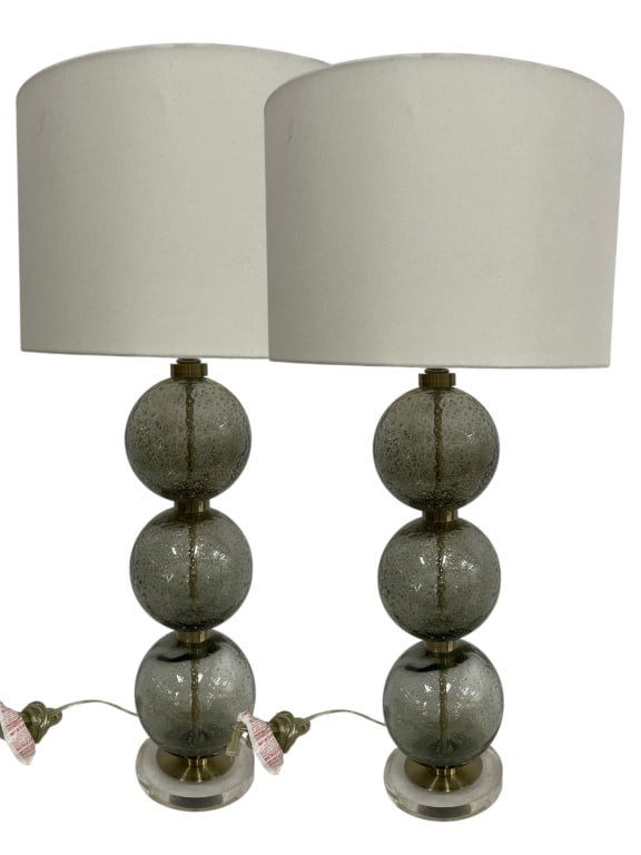 PAIR OF STACKED GLASS GLOBE TABLE LAMPS: *for alternative shipping options please go to www.dejavuauctionshipping.com -PAIR OF STACKED GLASS GLOBE TABLE LAMPS WITH DRUM SHADES -Striking pair of contemporary table lamps featuring three stacke