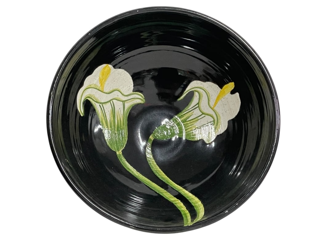 JAPANESE BLACK ART POTTERY BOWL W LILY 10": *for alternative shipping options please go to www.dejavuauctionshipping.com -JAPANESE BLACK ART POTTERY BOWL WITH CALLA LILY DESIGN -Striking art pottery serving bowl measuring approximately 10" diam