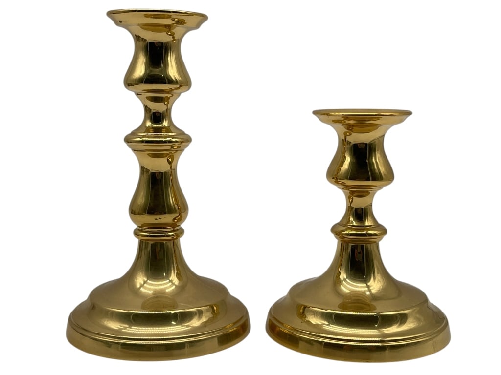 PAIR OF BRASS CANDLE HOLDERS TAPER CANDLESTICKS: PAIR OF POLISHED BRASS TAPER CANDLE HOLDERS IN MATCHING FORM Pair of polished brass taper candle holders in a classic traditional form, each with stepped circular base and baluster-style stem, present