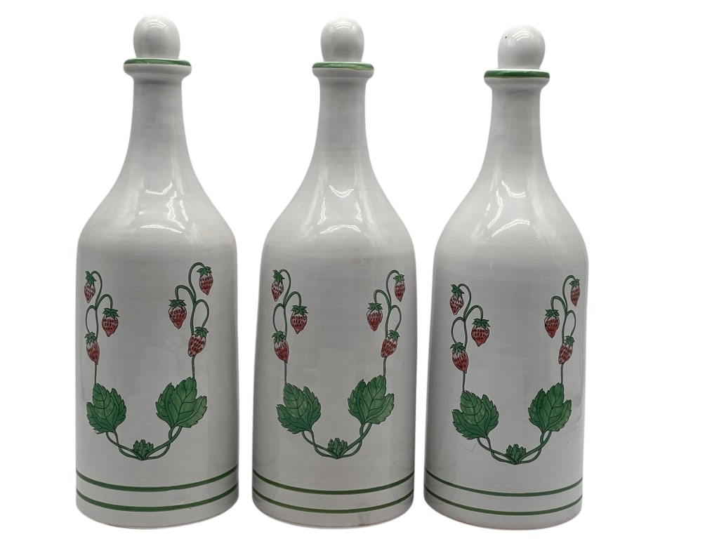 LOT OF 3 ITALIAN CERAMIC BOTTLES STRAWBERRY DISPLY: GROUP OF 3 HANDPAINTED ITALIAN CERAMIC BOTTLES WITH STRAWBERRY MOTIF Group of three Italian ceramic bottles with matching handpainted strawberry vine decoration on a white glazed ground. Each bottle f