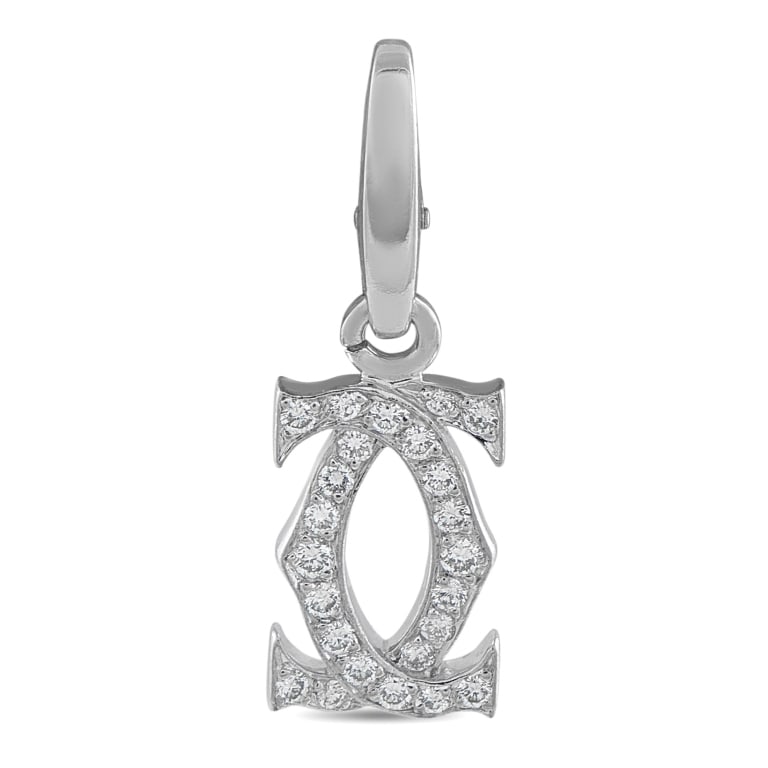 CARTIER DOUBLE C 18K WHITE GOLD DIAMOND CHARM: This Cartier Double C logo charm exudes upscale sophistication. Crafted from 18K White Gold, sparkling Diamonds make it instantly eye-catching. This iconic charm measures 1.0 long by 0.32 wide and is
