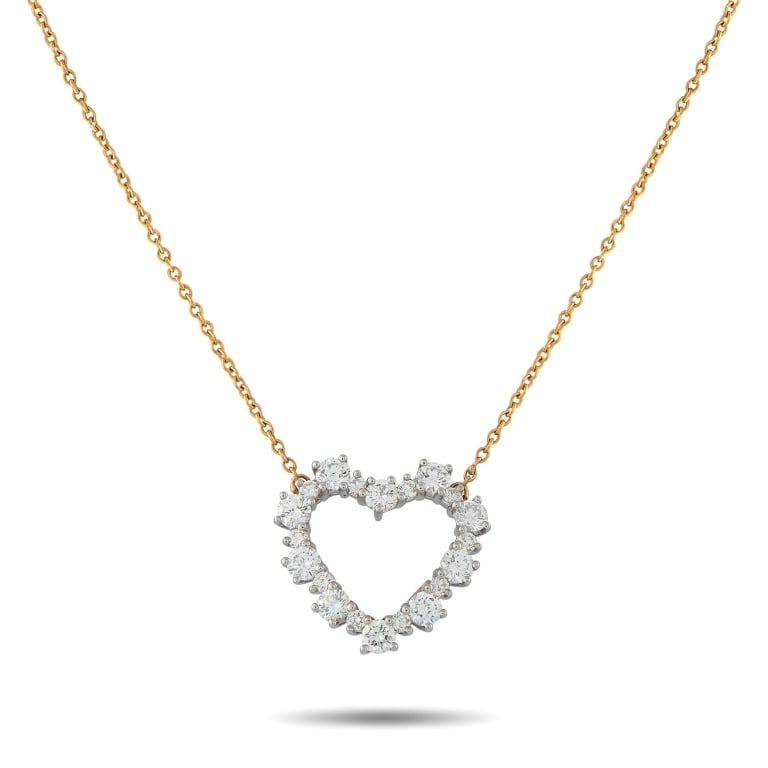 TIFFANY & CO. 18K 0.63CT DIAMOND HEART NECKLACE: This charming Tiffany & Co. necklace will instantly add a touch of sparkle to any ensemble. Crafted from a combination of 18K White Gold and 18K Yellow Gold, the heart-shaped pendant at the center shi