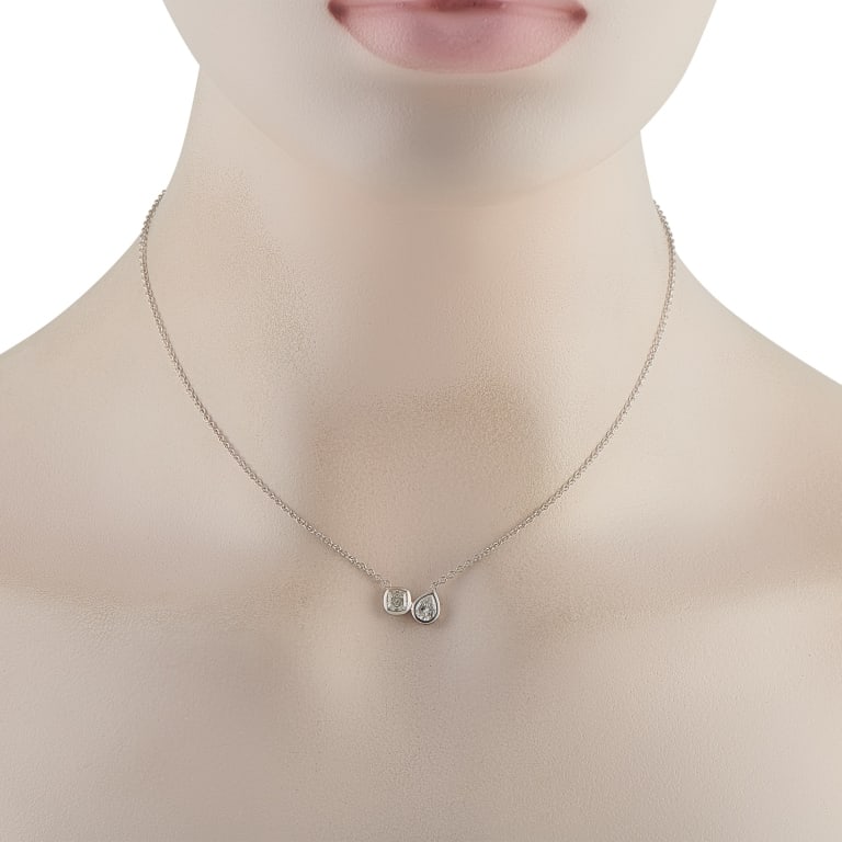 18K WHITE GOLD 1.0CT DIAMOND NECKLACE: This luxury necklace is sleek and incredibly contemporary in design. The 18K White Gold pendant makes a statement thanks to a cushion cut Diamond and a pear-shaped Diamond together, they possess a tot