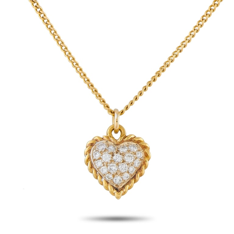 VAN CLEEF & ARPELS 18K GOLD DIAMOND HEART PENDANT: This Van Cleef & Arpels necklace is a timeless piece with a classic sense of sophistication. The heart-shaped pendant shines brightly thanks to sparkling inset Diamonds. Suspended from a 15 chain, the