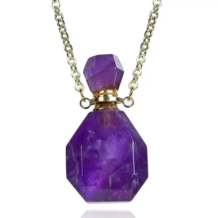 Gold Necklace With Amethyst Aroma Pendant: This gold necklace features an amethyst aroma pendant, a unique item combining natural stone beauty with functionality. The pendant is approximately 1" in diameter, designed to be filled with your fav